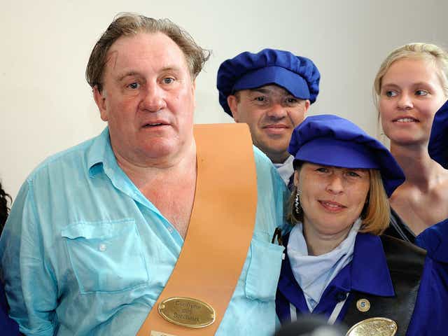 French actor Gerard Depardieu poses with people from Estaimpuis during a ceremony held in his honor at  the Chateau Bourgogne